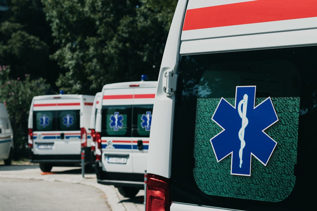 Three ambulances parked outdoors, ready for emergency healthcare situations.